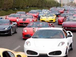 a bunch of sports cars in traffic