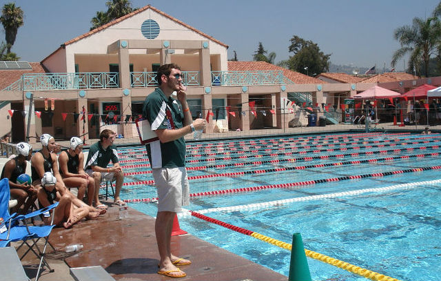 People standing next to a pool